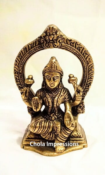 Laskshmi Devi Brass Statue with Prabavali - 13 cm x 8 cm Laskshmi Devi Brass Statue with Prabavali - 13 cm x 8 cm